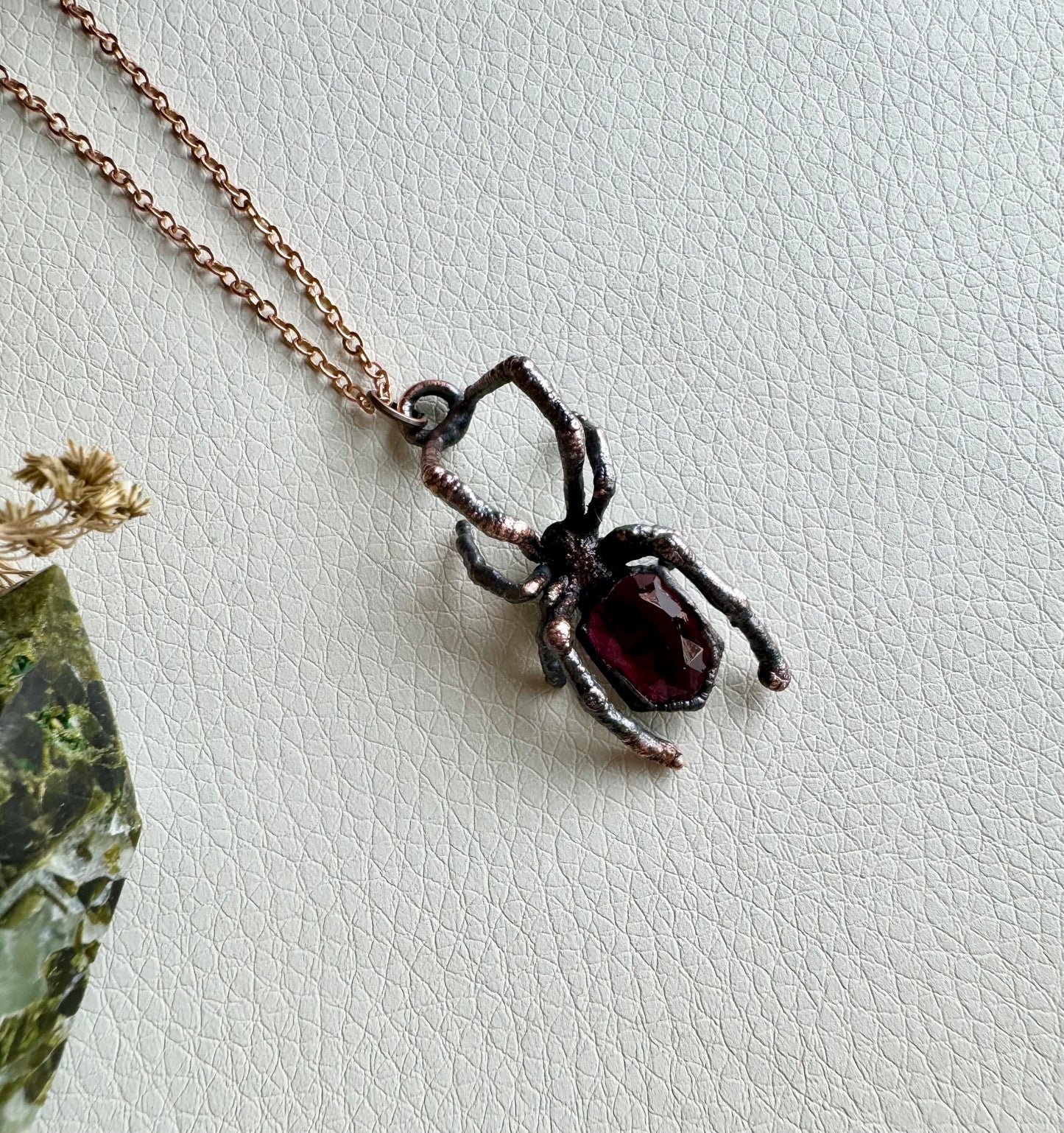 Real black widow with garnet necklace
