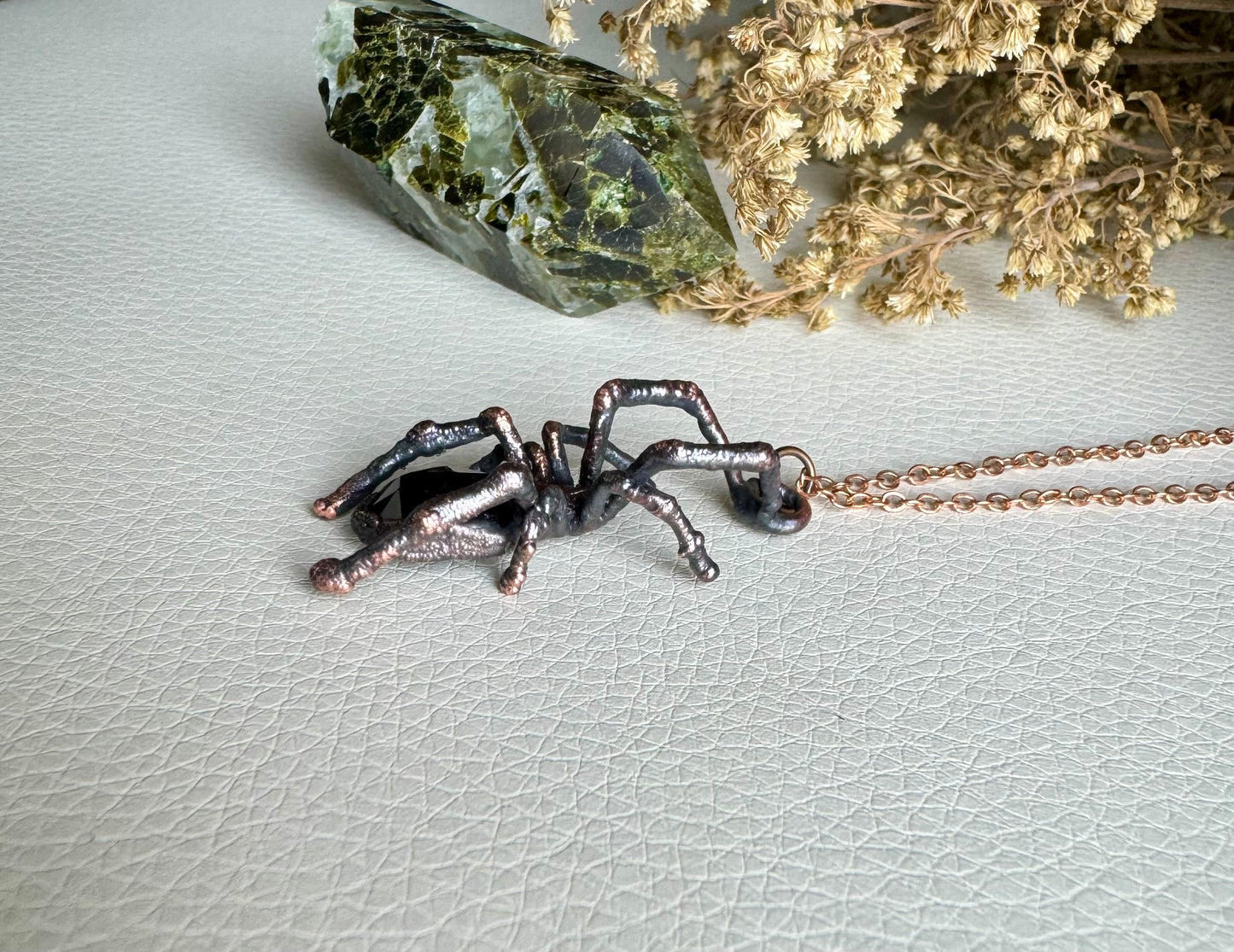 Real black widow with garnet necklace