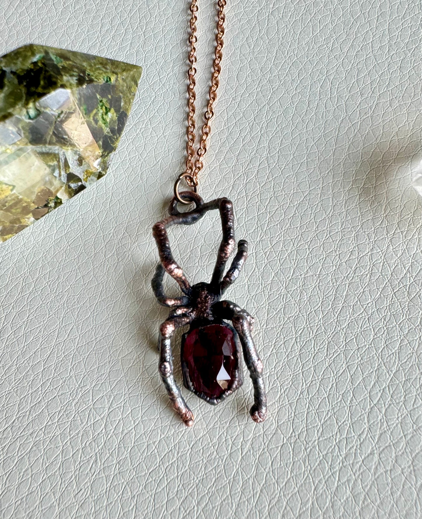 Real black widow with garnet necklace