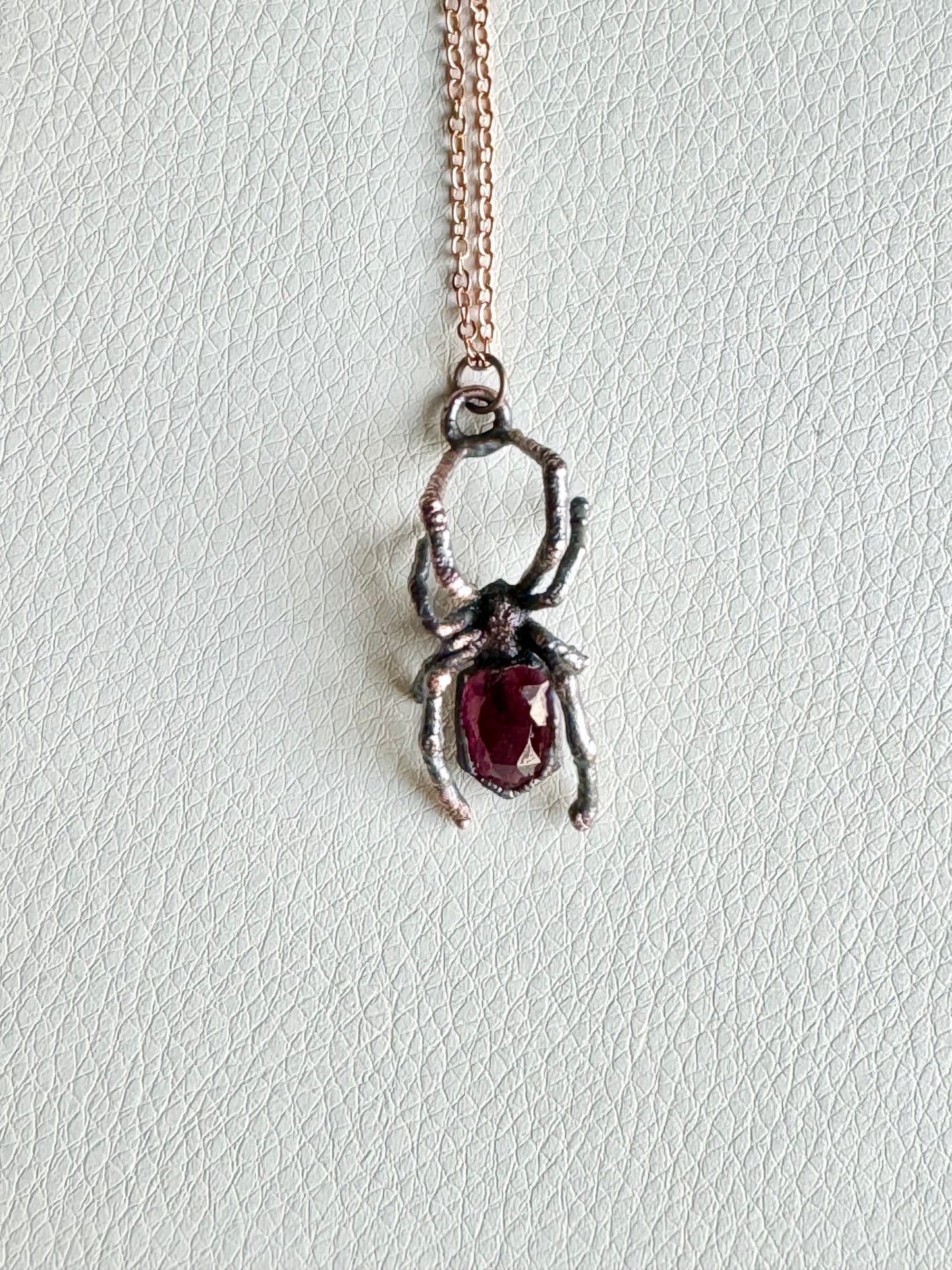 Real black widow with garnet necklace