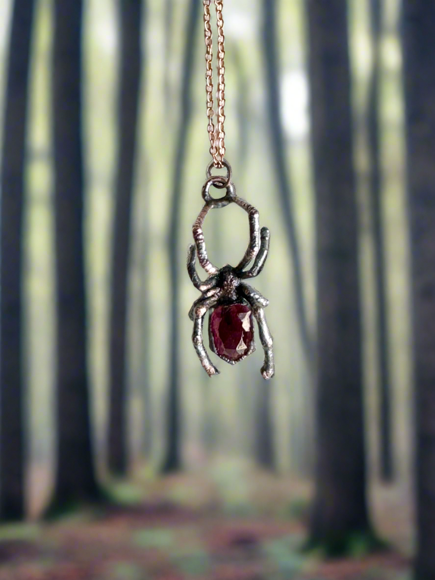 Real black widow with garnet necklace