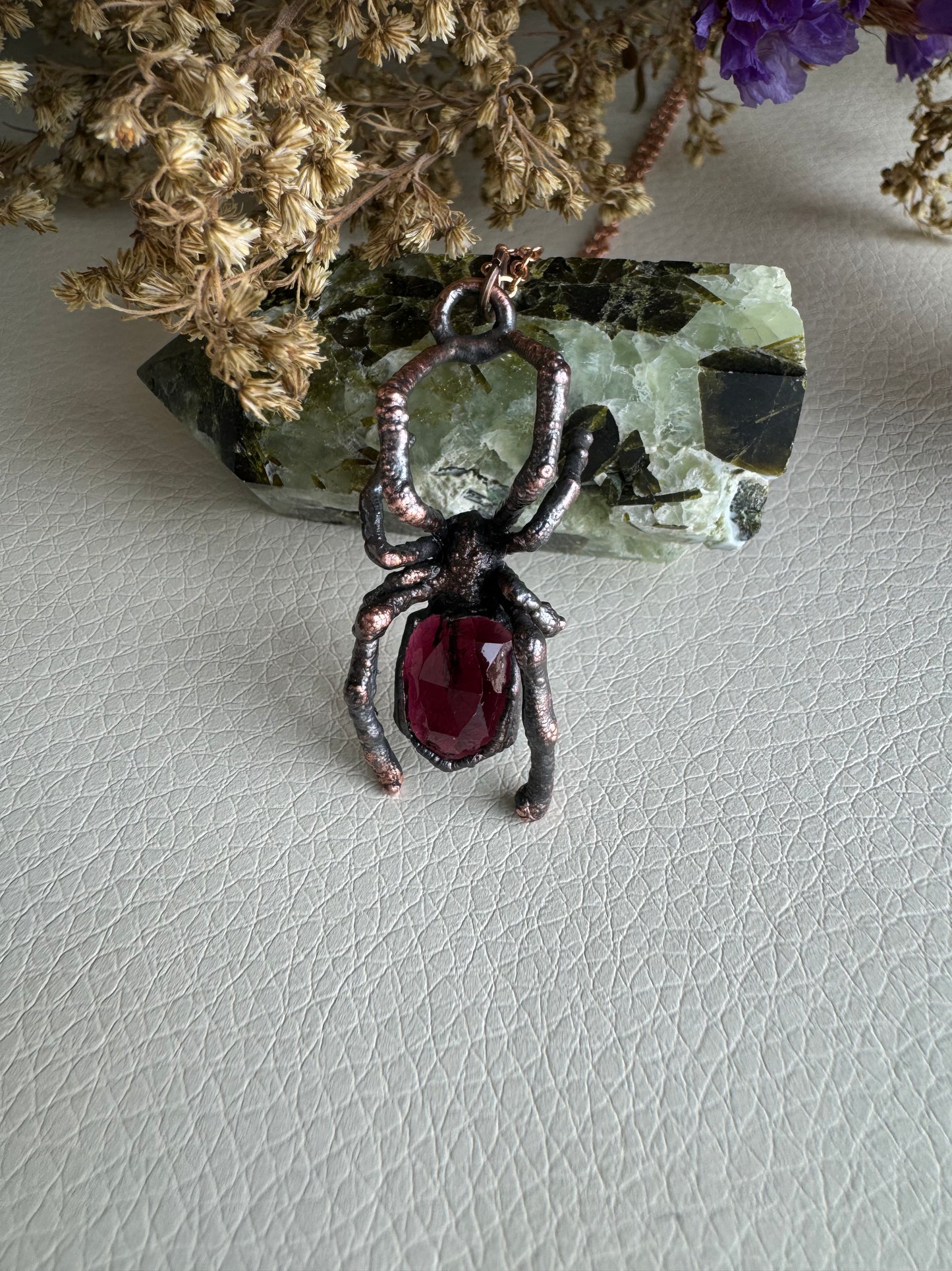 Real black widow with garnet necklace